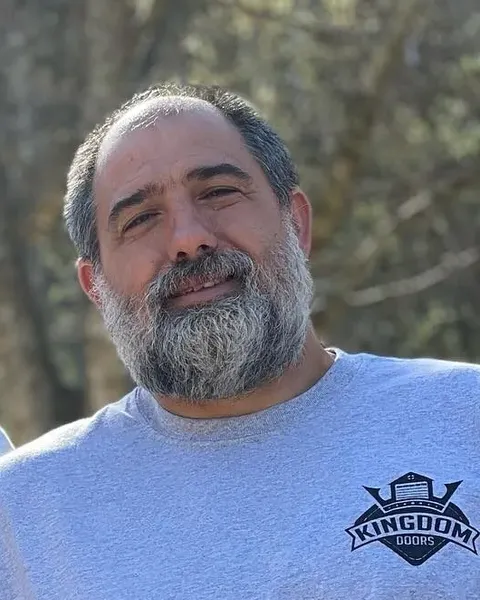 Chad Caro, founder of Kingdom Doors, in a gray company hoodie
