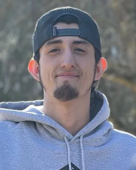 Clay Caro, co-owner of Kingdom Doors, in a gray company hoodie